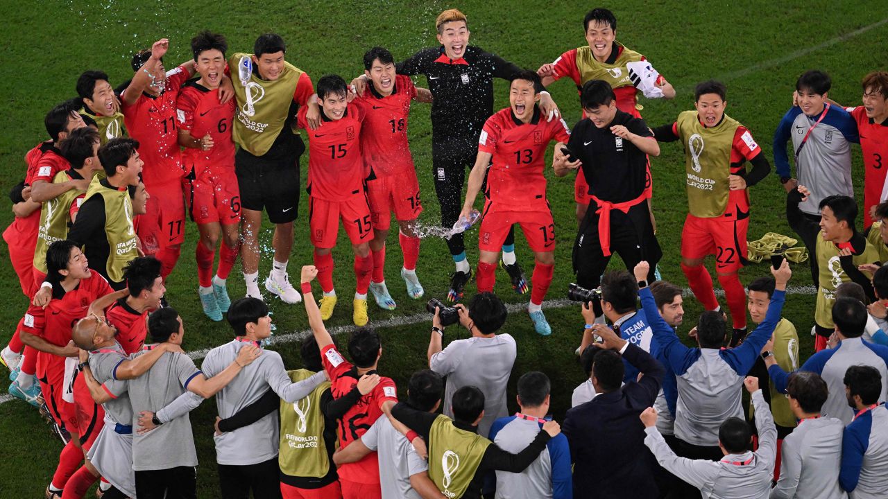 South Korea's players celebrate their victory over Portugal and the team's qualification for the knockout phase of the 2022 World Cup.