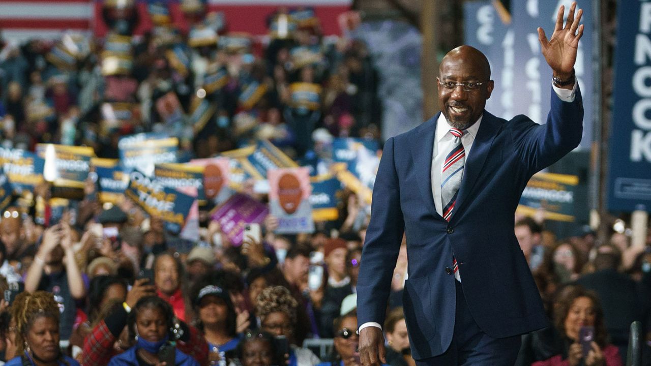 Sen. Raphael Warnock, a Democrat from Georgia, walks on stage during a campaign rally in Atlanta on December 1, 2022.