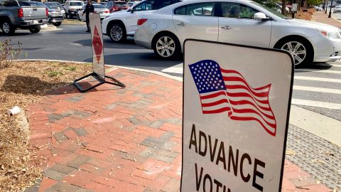 A sign showing the way for voters stands outside a Cobb County voting building during the first day of early voting, October 17, 2022, in Marietta, Georgia.