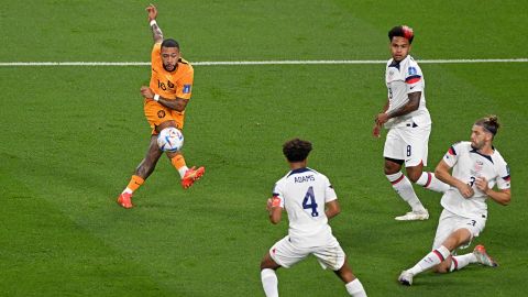 Netherlands' Memphis Depay strikes the ball to score his team's first goal during the Qatar 2022 World Cup round of 16 football match between the Netherlands and USA.