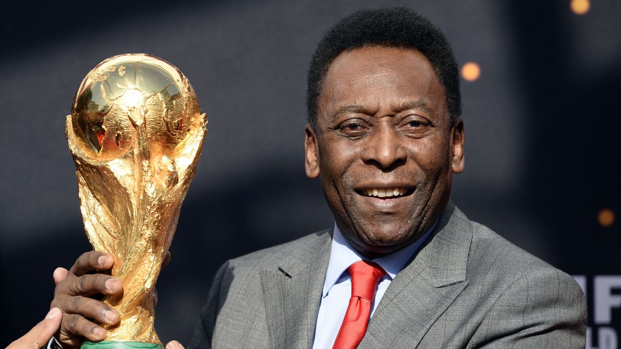 Pelé poses with the World Cup trophy on March 9, 2014, in Paris.