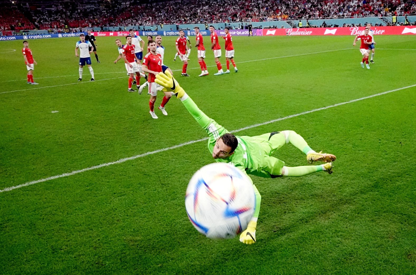 Rashford's free kick whizzes by Wales' Danny Ward for England's first goal.