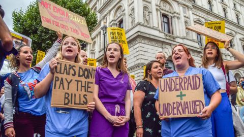 Protesters hold placards demanding fair pay for healthcare workers during a demonstration outside Downing Street.