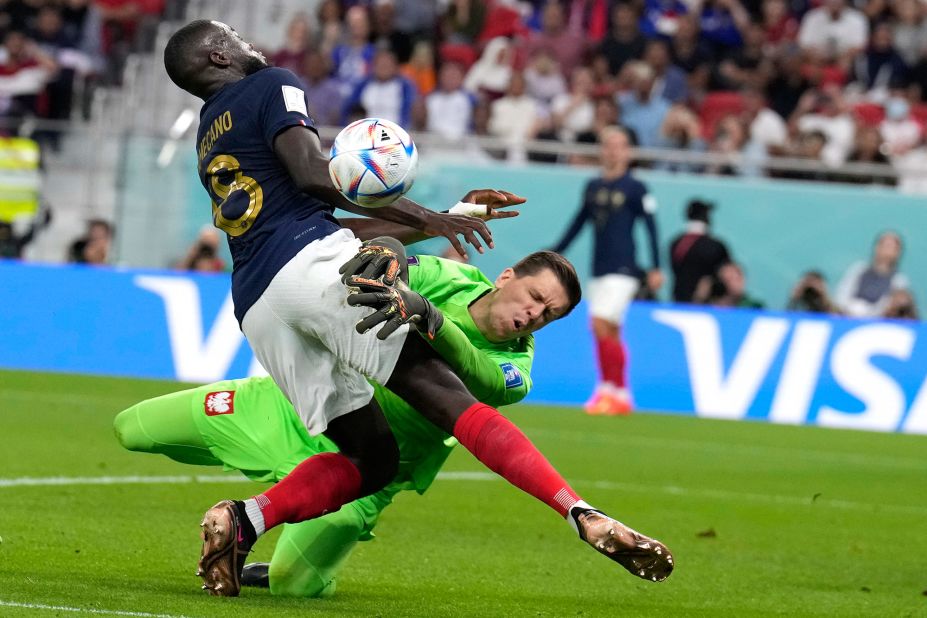 France's Dayot Upamecano collides with Poland goalkeeper Wojciech Szczesny.