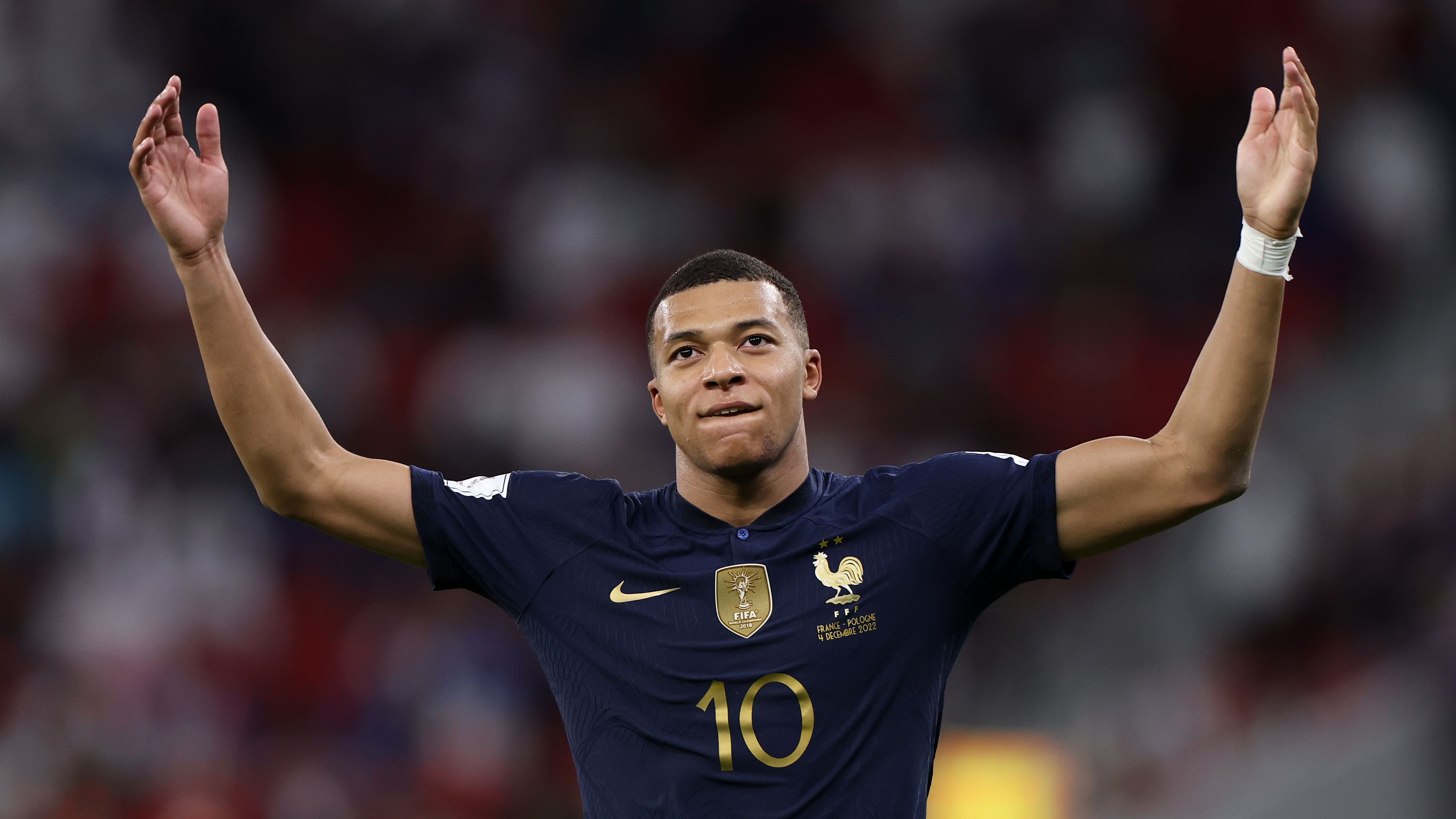 Kylian Mbappe celebrates after scoring his second goal against Poland.