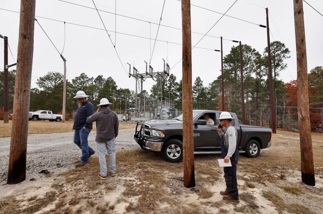 Duke Energy workers gather Sunday as they plan how to repair an electrical substation in Carthage, North Carolina.