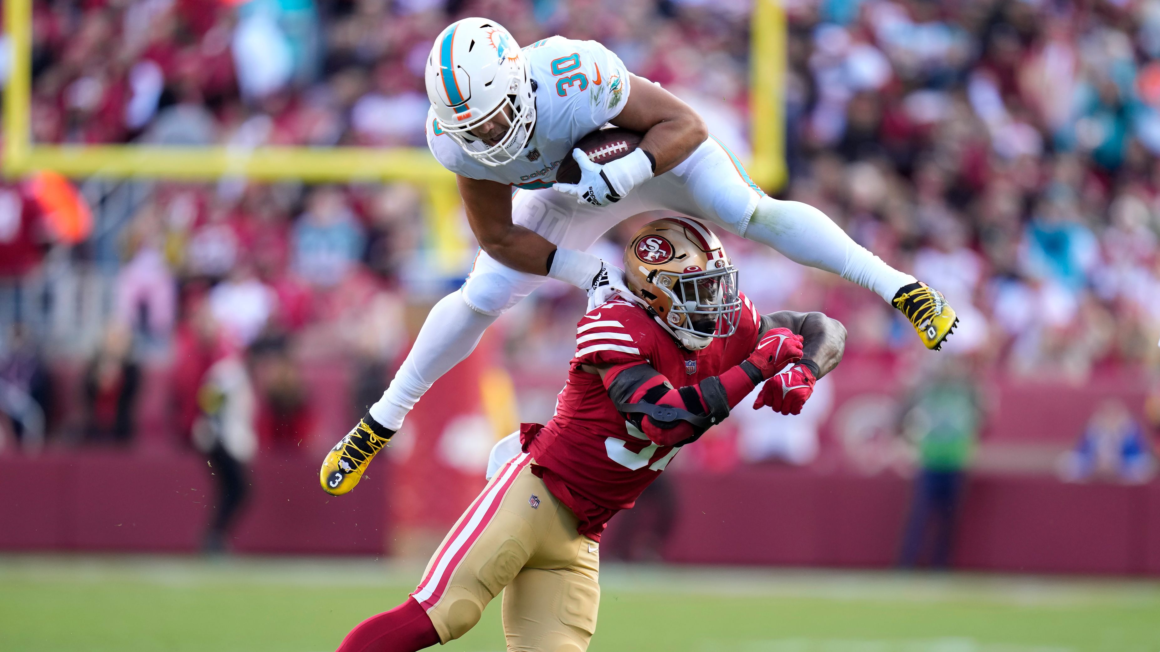 Miami Dolphins fullback Alec Ingold hurdles over San Francisco 49ers linebacker Dre Greenlaw during the first half of the teams' game. The 49ers, despite losing starting quarterback Jimmy Garoppolo to a season-ending injury early on, beat the Dolphins 33-17. 