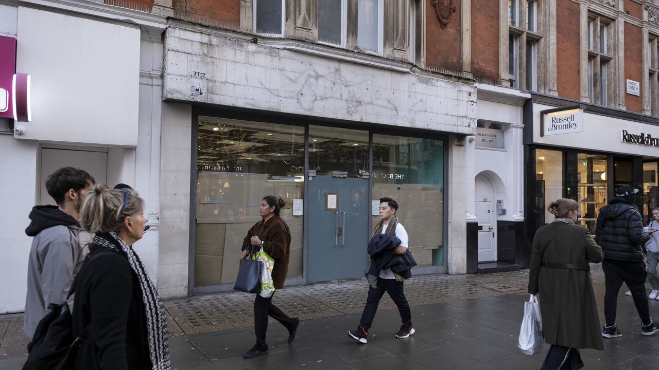 Shoppers pass a closed down retail shop space on Oxford Street in London, United Kingdom on November 15, 2022.