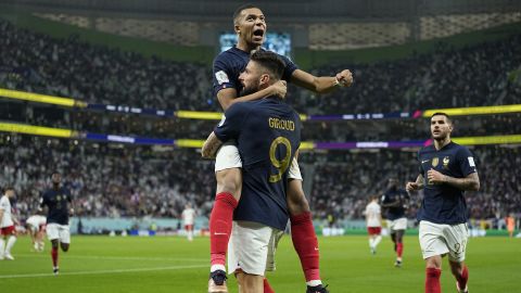 France's Olivier Giroud celebrates with Kylian Mbappe after scoring the opening goal against Poland at the 2022 World Cup. 
