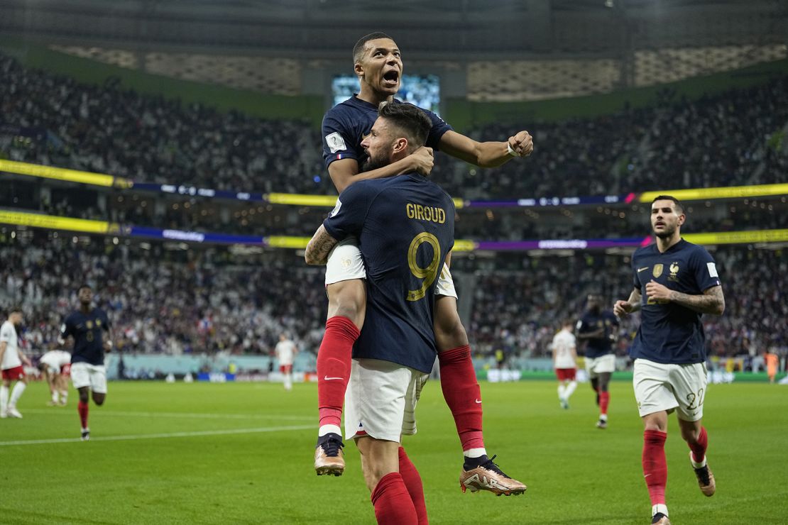France's Olivier Giroud celebrates with Kylian Mbappé after scoring the opening goal against Poland at the 2022 World Cup. 