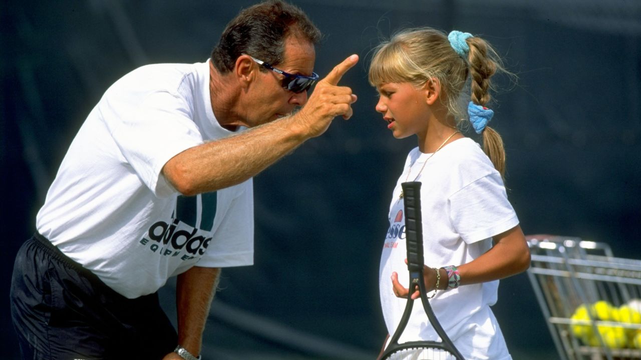 Bollettieri gives instructions to a young Anna Kournikova during a training session at his Tennis Academy in Bradenton, Florida.