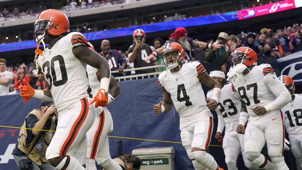Watson runs onto the field with his team for the game against the Texans.