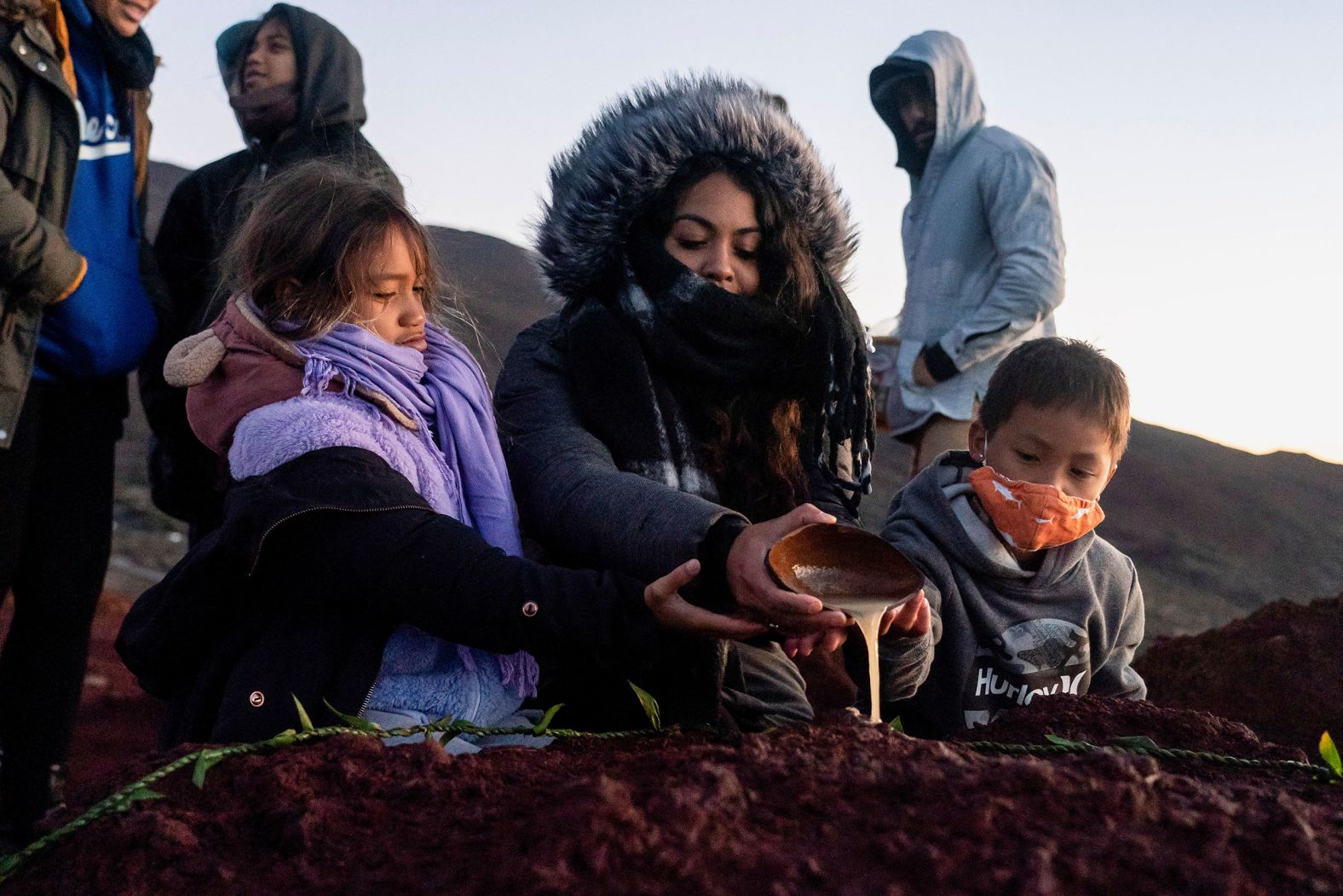 Locals dedicate a traditional drink to Pele, the goddess of volcanoes and fire, on December 3.