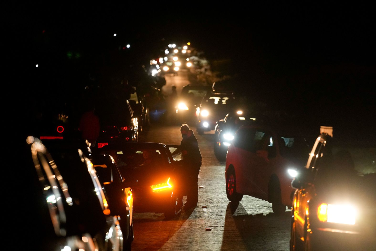 Motorists make their way through Hilo as people search for a volcano vantage point on December 2.