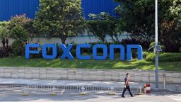 A man passes by a compound of the electronics manufacturer Foxconn, which is under strict access control to prevent Covid-19, in Shenzhen in south China's Guangdong province on Saturday, September 03, 2022. 