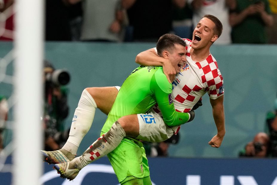 Mario Pasalic, right, celebrates with goalkeeper Dominik Livaković after Croatia won a penalty shootout over Japan. Livaković made three saves in the shootout after the match ended 1-1.