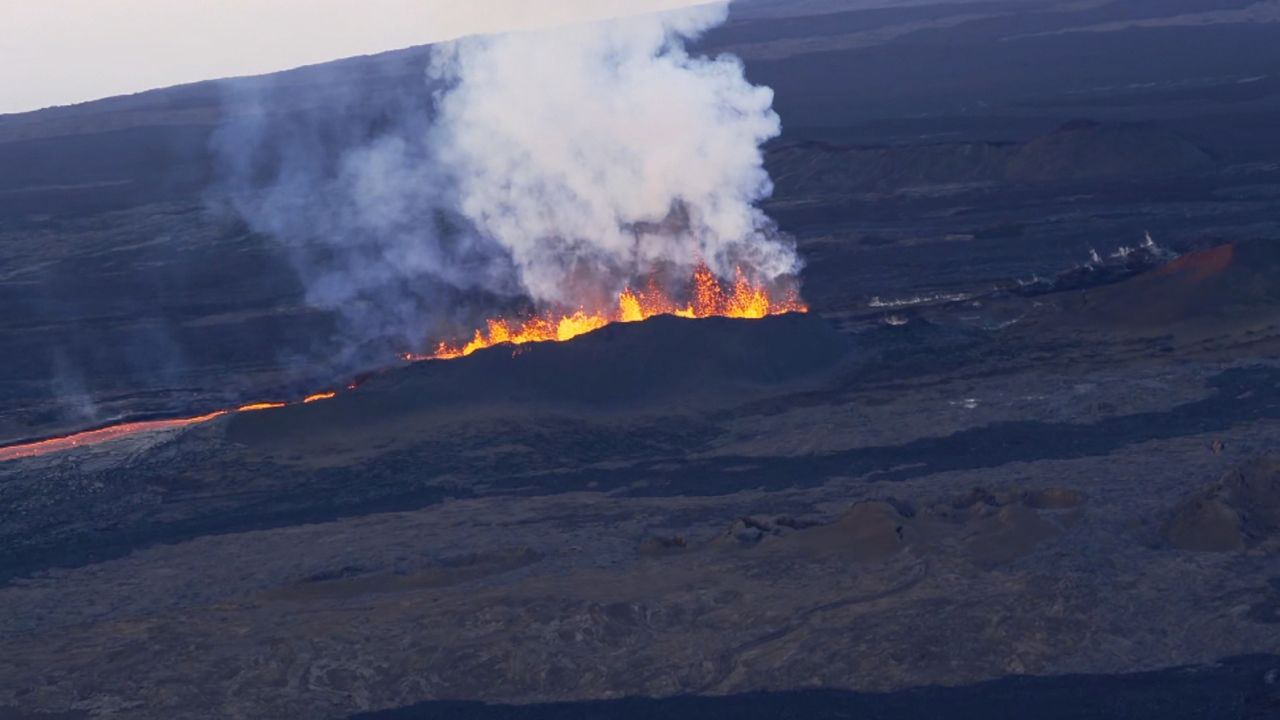 Lava spews Sunday from a fissure on Mauna Loa, where heat rises and a sulfuric smell wafts a quarter-mile into the air.