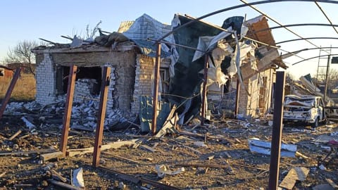In this photo provided by the Zaporizhzhia region military administration, a damaged building and a car are seen after a Russian strike in the village of Novosofiivka, in the Zaporizhzhia region, Ukraine, Monday, Dec. 5, 2022. Ukrainian officials reported a new barrage of Russian missile strikes across the country Monday, an attack that was anticipated as Russia seeks to disable Ukraine's energy supplies and infrastructure with the approach of winter. (Zaporizhzhia region military administration via AP)