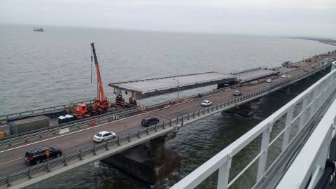 Workers pictured repairing damage to the bridge on November 19.