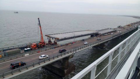 Workers pictured repairing damage to the bridge on November 19. 