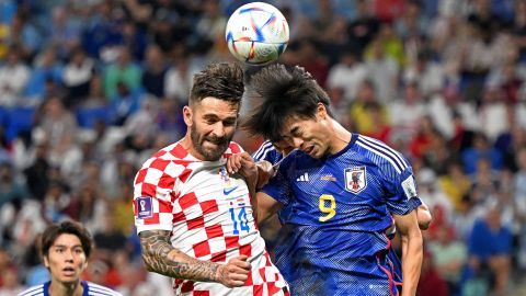 Croatia's forward #14 Marko Livaja fights for the header with Japan's forward #09 Kaoru Mitoma.
