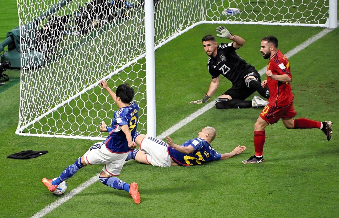 Kaoru Mitoma crosses the ball on the goal line to help set up Japan's winning goal in the 2-1 win against Spain.