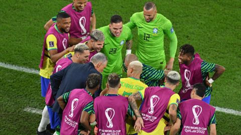 Tite joins in with the celebrations after Richarlison's goal.