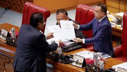 Bambang Wuryanto, head of the parliamentary commission overseeing the revision, passes the report of the new criminal code to Sufmi Dasco Ahmad, Deputy speaker of the House of Representatives, during a parliamentary plenary meeting in Jakarta, Indonesia, December 6, 2022. REUTERS/Willy Kurniawan