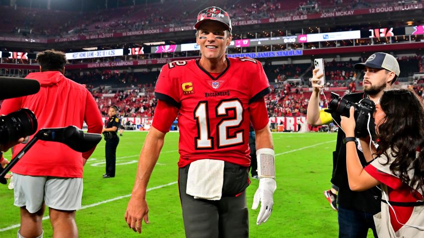  Tom Brady #12 of the Tampa Bay Buccaneers runs off the field after defeating the New Orleans Saints in the game at Raymond James Stadium on December 05, 2022 in Tampa, Florida. The Tampa Bay Buccaneers defeated the New Orleans Saints with a score of 17 to 16. (Photo by Julio Aguilar/Getty Images)