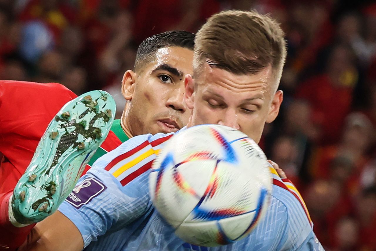 Hakimi tries to win the ball from Spain's Dani Olmo, seen in the foreground.