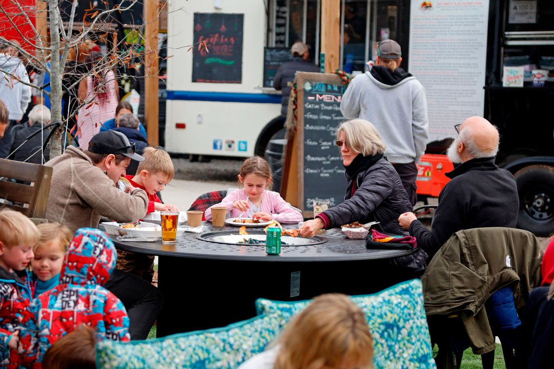 Residents of Southern Pines have lunch Monday while the power is out in the area at Reds Food Truck Corner.