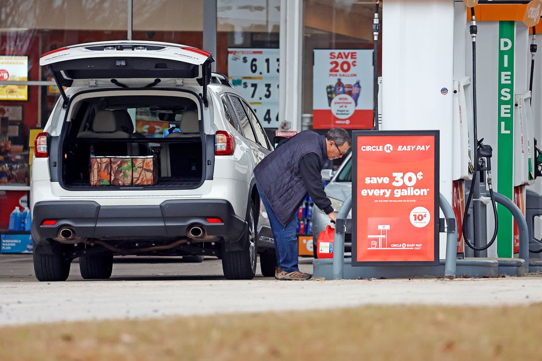 Residents fill gas containers Monday just outside the area impacted by the power outage.