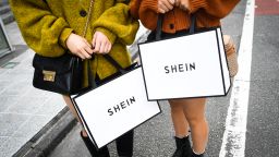 Customers hold Shein bags outside the Shein Tokyo showroom in Tokyo, Japan, on Sunday, November 13, 2022. 