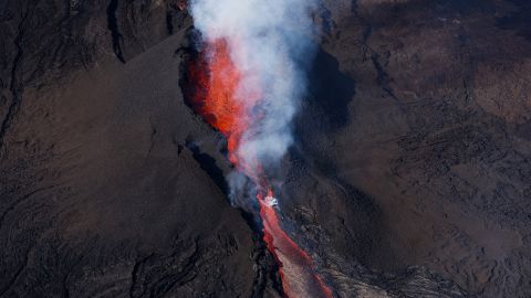In an aerial view, lava shoots up from a fissure of the Mauna Loa Volcano as it erupts Monday in Hilo, Hawaii. 