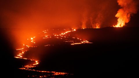 Lava fountains and flows create a glow at the Mauna Loa Volcano eruption in Hawaii Monday.