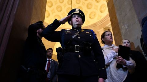 A U.S. Capitol Policeman salutes during a Congressional Gold Medal ceremony in the U.S. Capitol Rotunda in Washington, DC, on Dec. 6, 2022, in recognition of U.S. Capitol Police and those who protected the Capitol on Jan. 6, 2021.