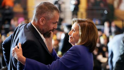 House Speaker Nancy Pelosi of California hugs former Washington Metropolitan Police Department officer Michael Fanon before the start of the Congressional Gold Medal ceremony.