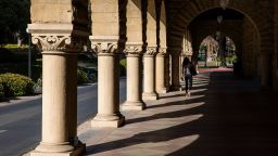 STANFORD, CA - MARCH 09: A person walks past archways during a quiet morning at Stanford University on March 9, 2020 in Stanford, California. Stanford University announced that classes will be held online for the remainder of the winter quarter after a staff member working in a clinic tested positive for the Coronavirus. (Photo by Philip Pacheco/Getty Images)