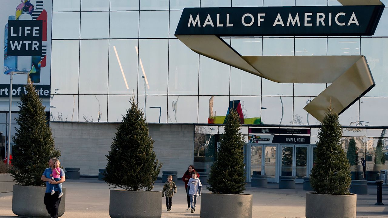 Shoppers, visitors and employees exit the Mall of America on March 17, 2020.