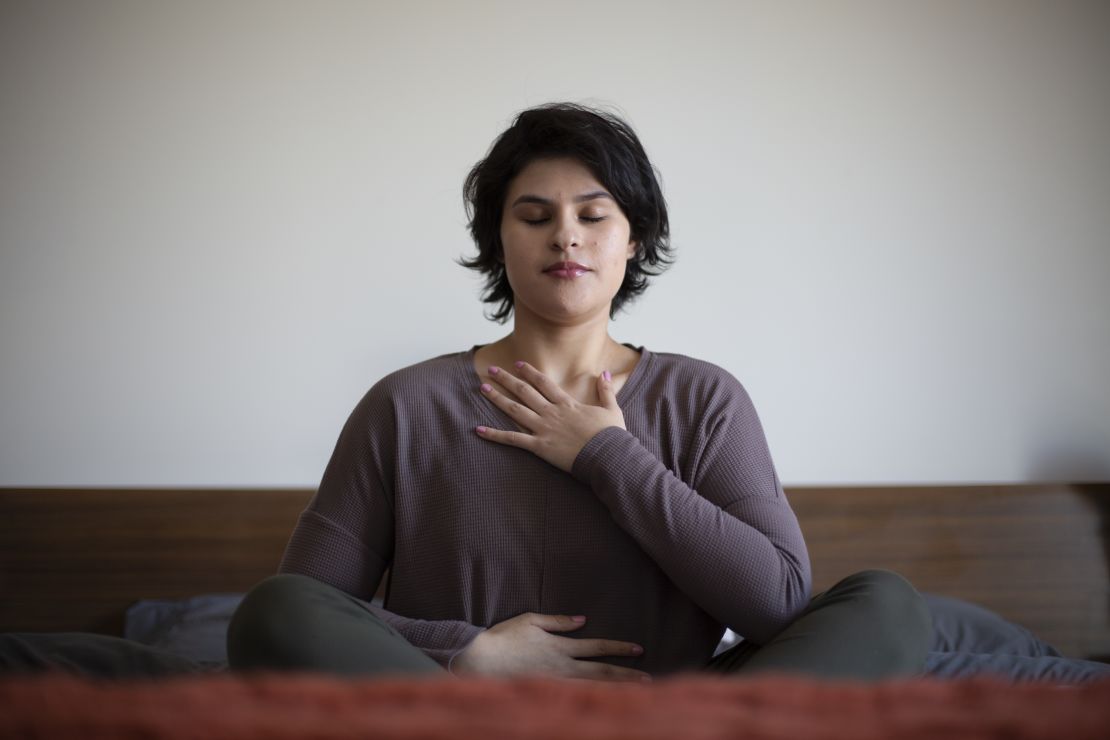 When she finds a moment, Zaldaña likes to meditate to calm her nerves. Here, she practices deep breathing on her bed, a routine she does often.