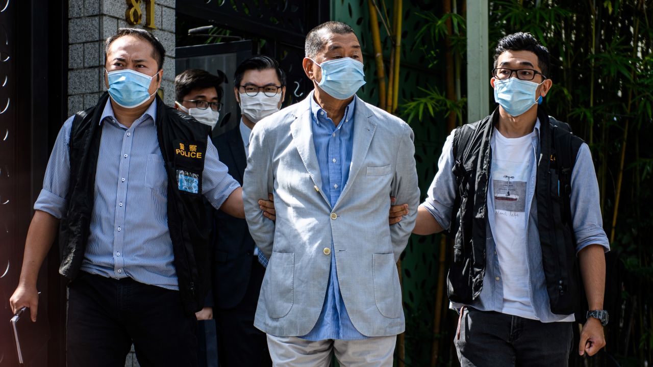 Police lead Hong kong pro-democracy media mogul Jimmy Lai away from his home after he was arrested under the new national security law in Hong kong on August 10, 2020. 