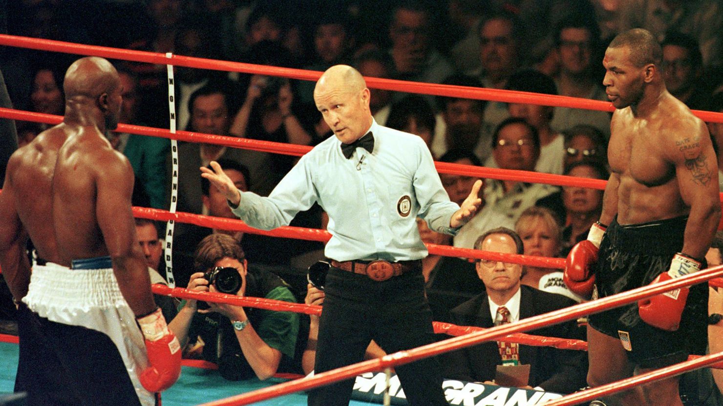 Referee Mills Lane steps between World Boxing Association heavyweight champion Evander Holyfield and challenger Mike Tyson during the third round of their rematch in June 1997.