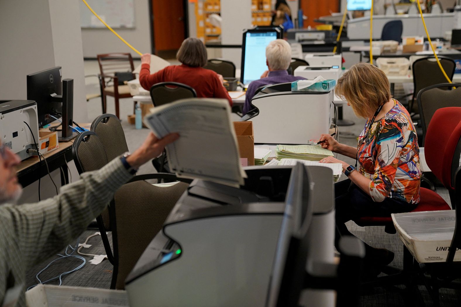 Election workers process ballots Tuesday at the Cobb County Elections and Registration Center in Marietta, Georgia.