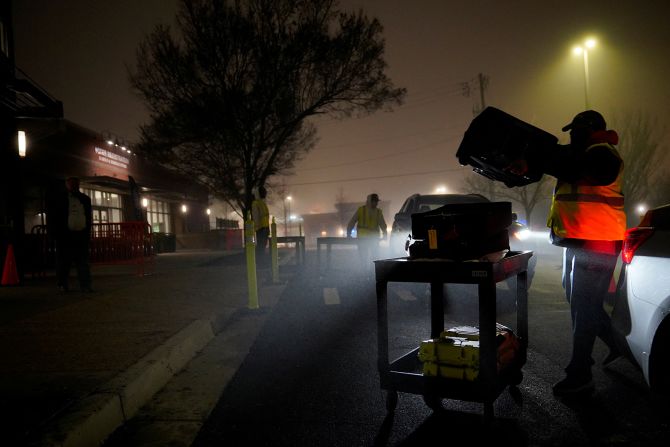 Election workers unload ballots in Marietta after polls closed on Tuesday night.