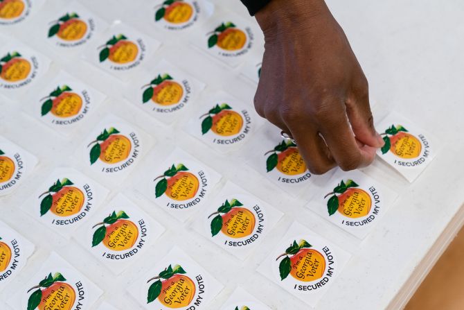 An election worker replaces a voting sticker at a polling location in Atlanta on Tuesday.