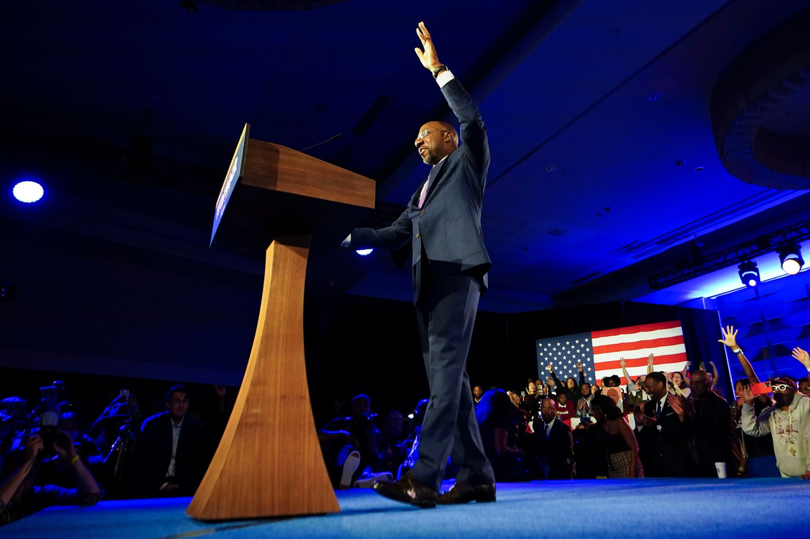 Warnock walks onto the stage to speak at his election night party in Atlanta on Tuesday.