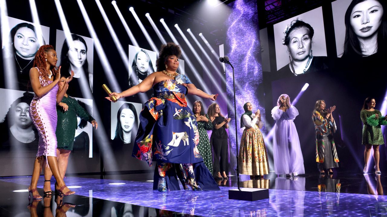 Honoree Lizzo (C) accepts The People's Champion award on stage during the 2022 People's Choice Awards held at the Barker Hangar on December 6, 2022 in Santa Monica, California.