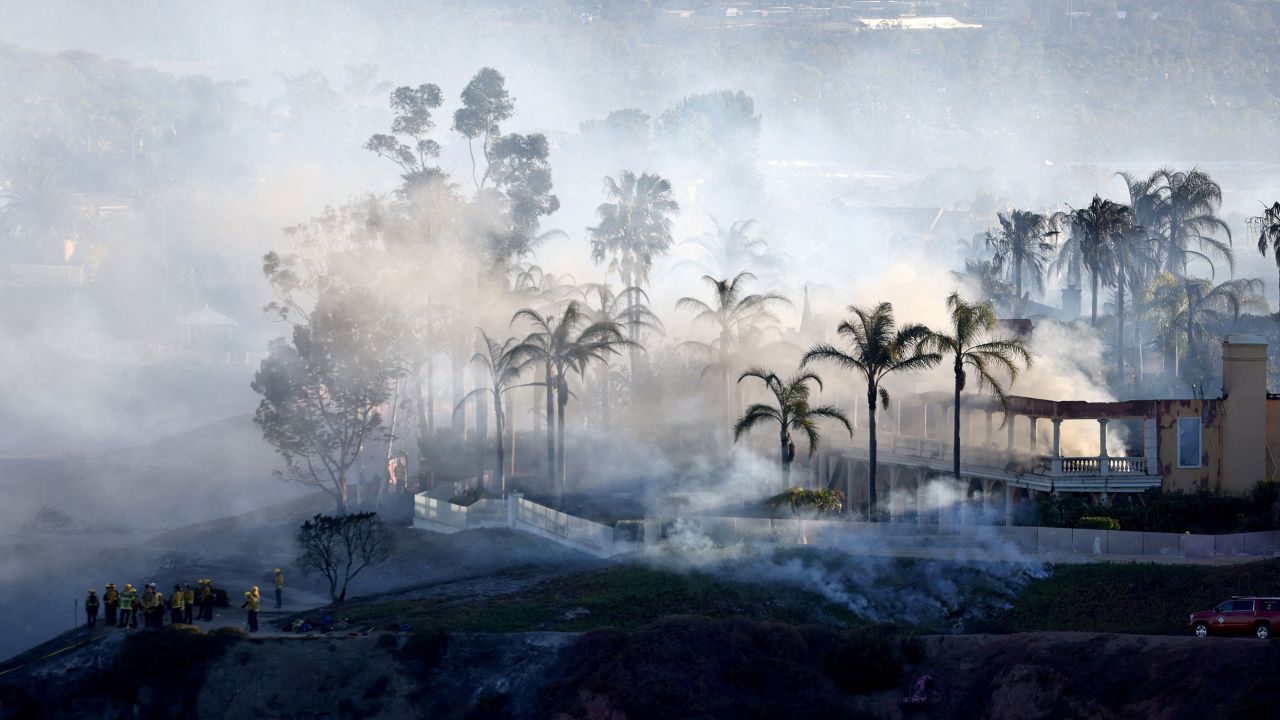 Smoke from a fast-moving, wind-driven wildfire rises above a residential area in Laguna Niguel, California, in May.