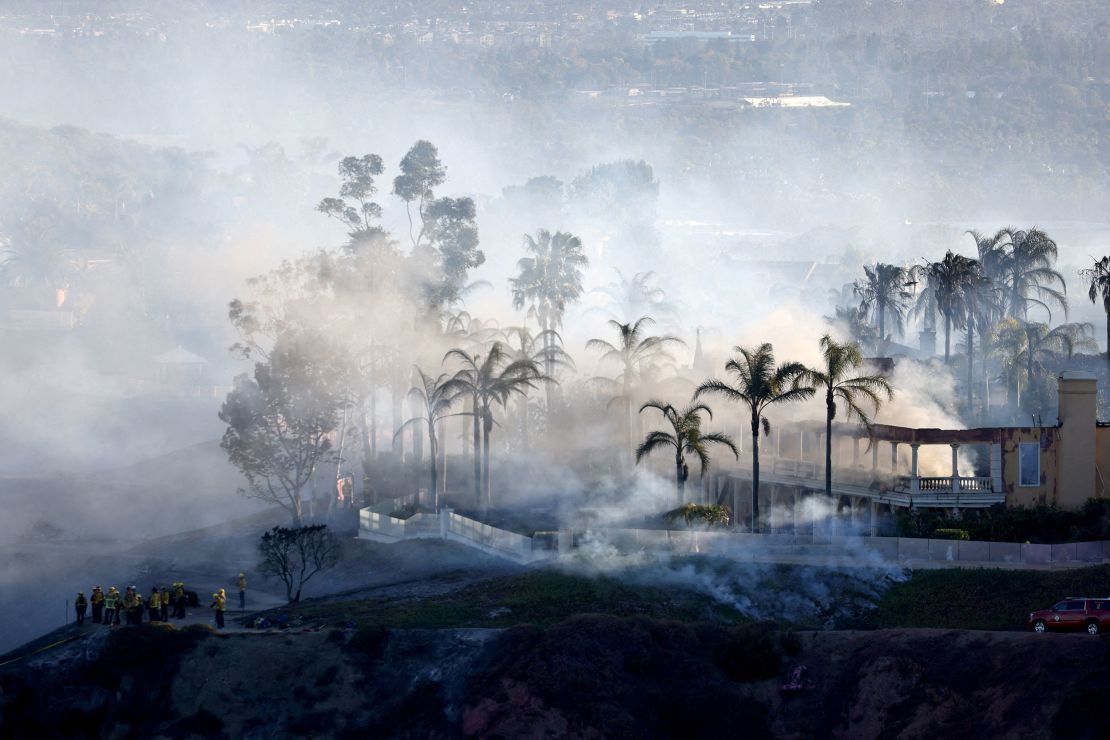 Smoke from a fast-moving, wind-driven wildfire rises above a residential area in Laguna Niguel, California, in May.