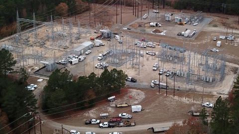 Duke Energy workers repair a crippled electrical substation that officials say was hit by gunfire, causing a massive power outage in Moore County, North Carolina.